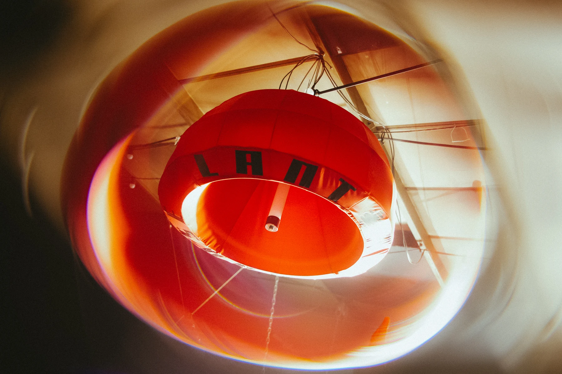 A red Lantern House lantern reflected in a circular mirror